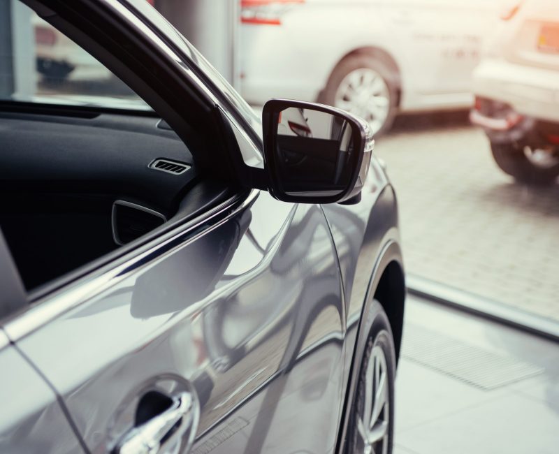 part retro car close-up. of the car in the spacious showroom with large windows.